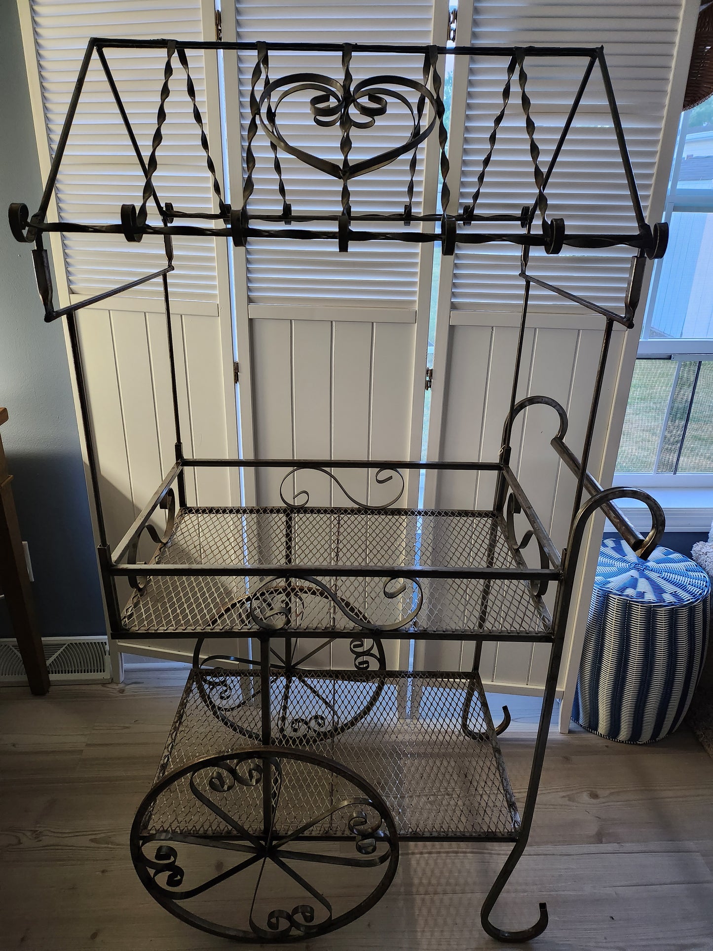 Wrought iron flower cart with heart motif and bottom shelf