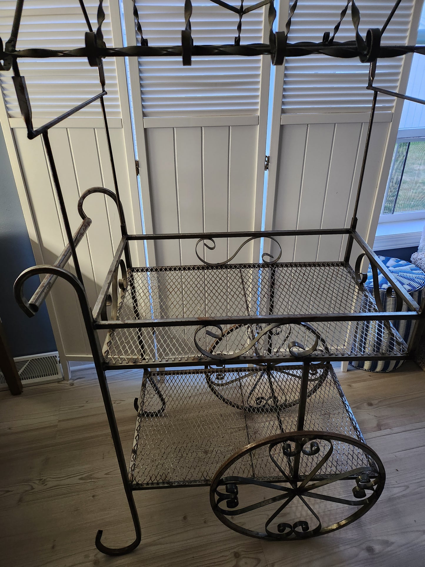 Side view of wrought iron flower cart
